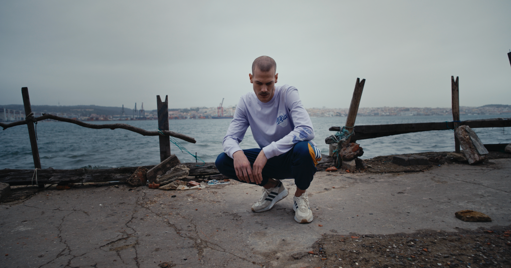 pastelle voodoo longsleeve heavyweight cotton shirt on model crouching in lisbon