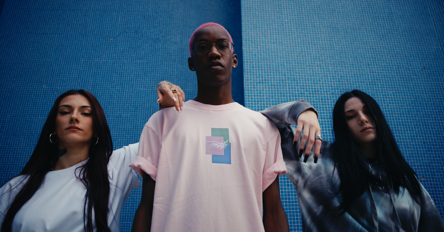closeup shot 3 models in white ELLEX PASTELLE oversized tee another in salmon coloured DAYDREAMING oversized box fit tee and a PASTELLE hoodie